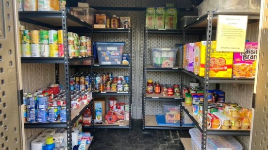 Inside the Garnet Valley Food Pantry with shelves stocked with donated food and supplies
